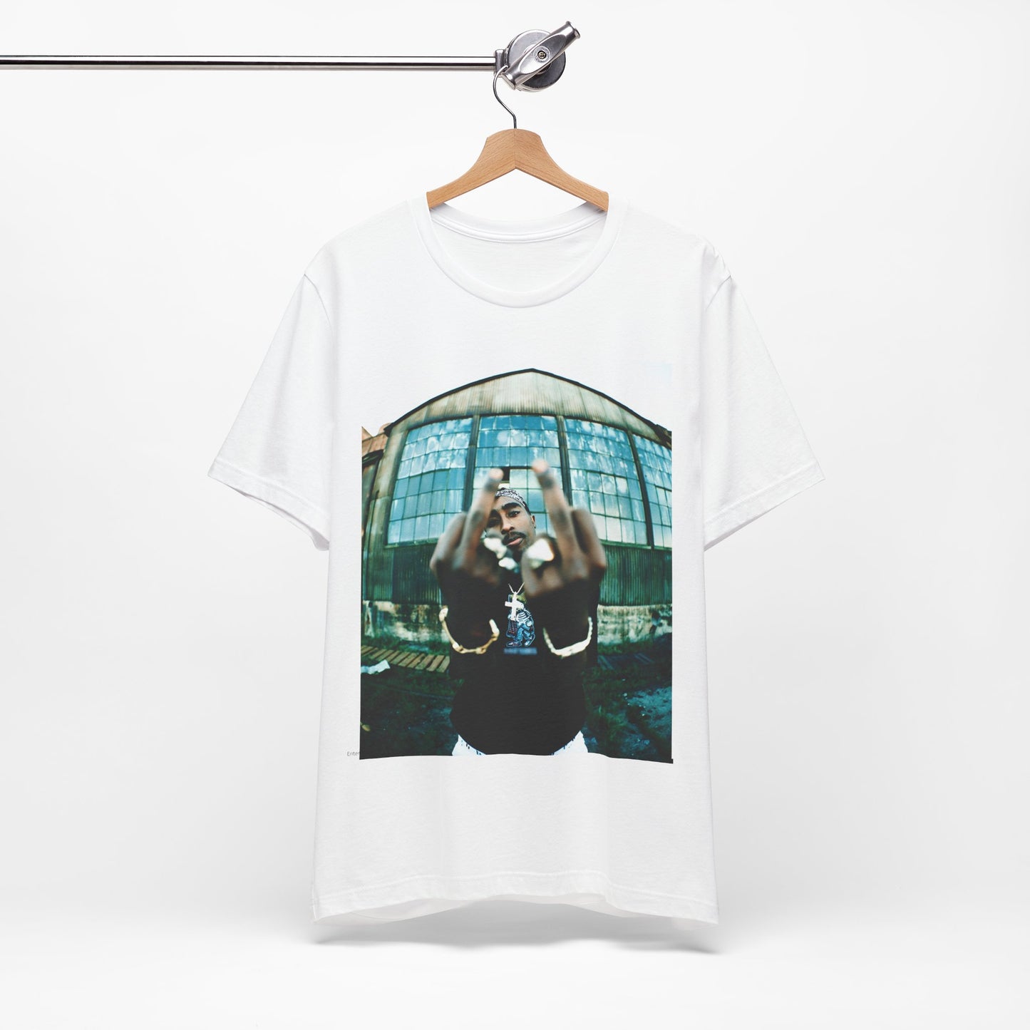 A black graphic t-shirt featuring a graphic of Tupac giving the middle finger.