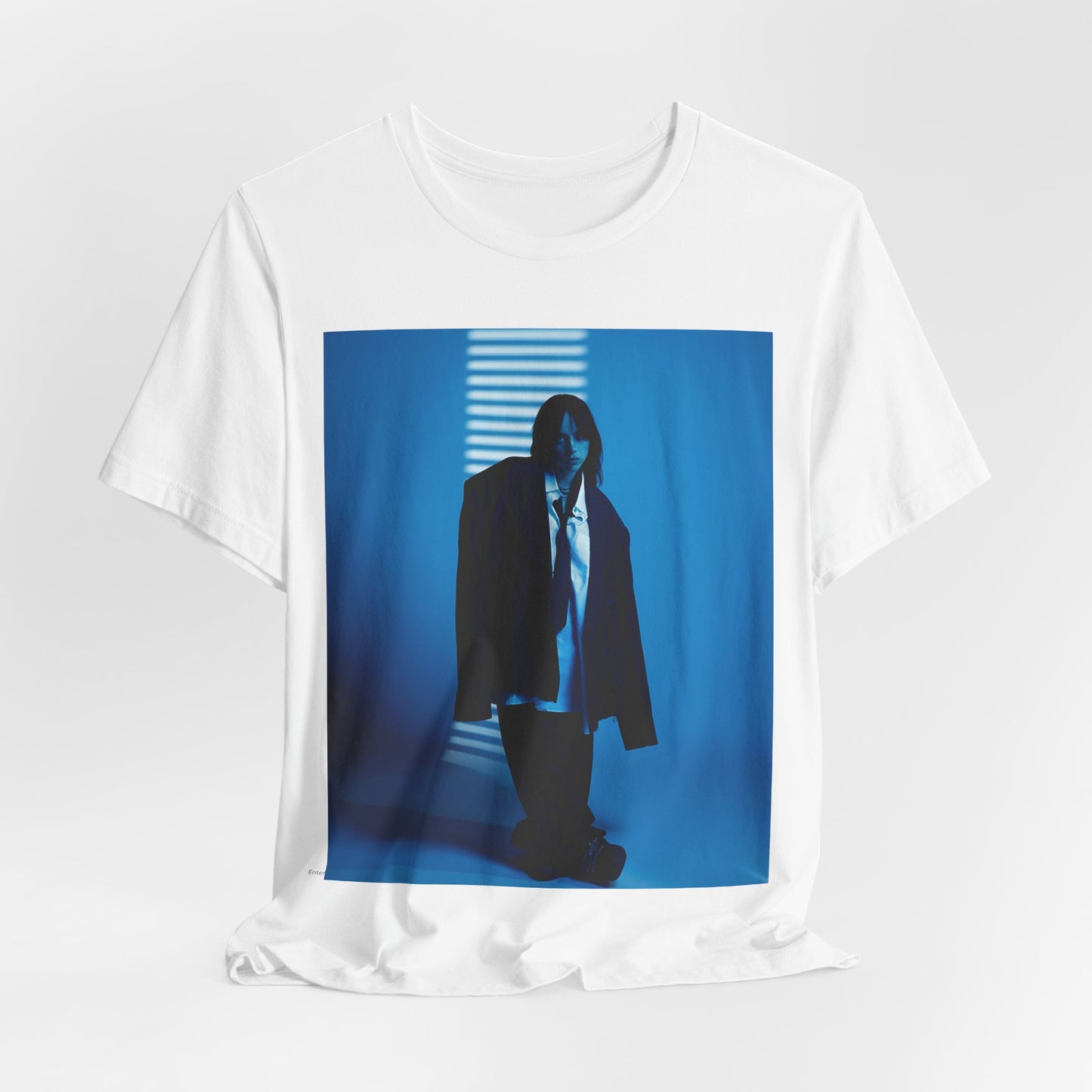 A high-fashion, editorial-style photo of Billie Eilish, embodying a 'breaking the rules' attitude, printed on a graphic t-shirt.