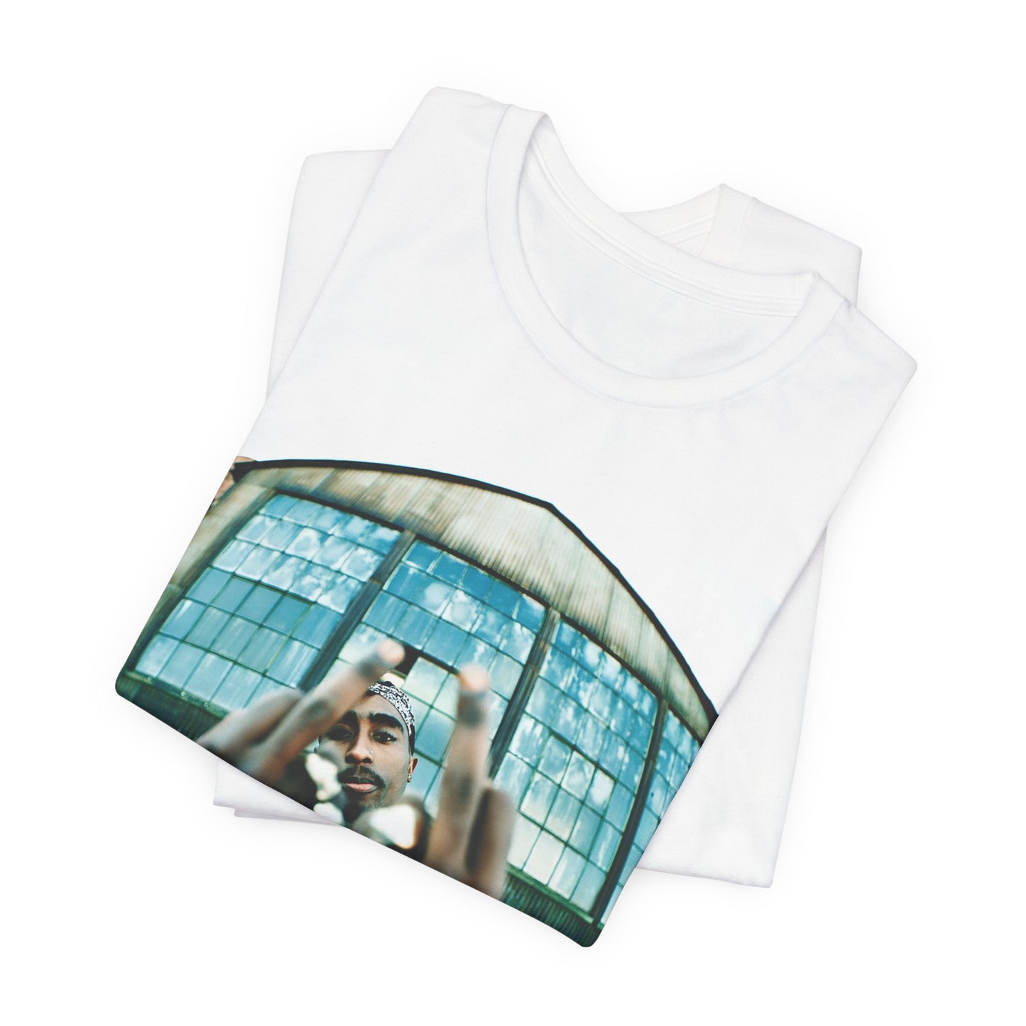 A black graphic t-shirt featuring a graphic of Tupac giving the middle finger.