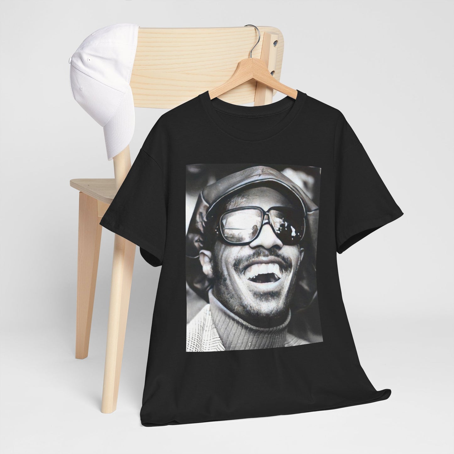 A black graphic t-shirt featuring a black and white portrait photo of Stevie Wonder.