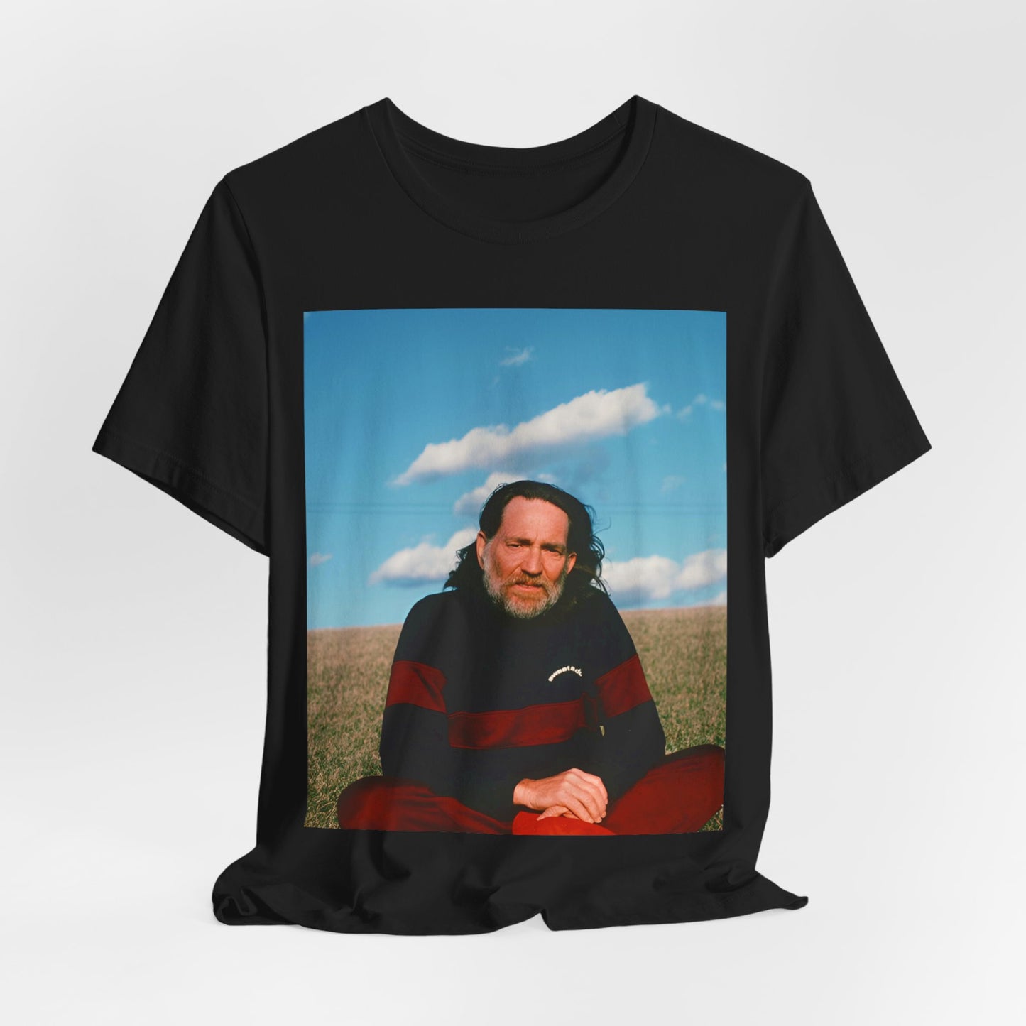 A black graphic t-shirt featuring a classic outlaw country graphic of Willie Nelson.