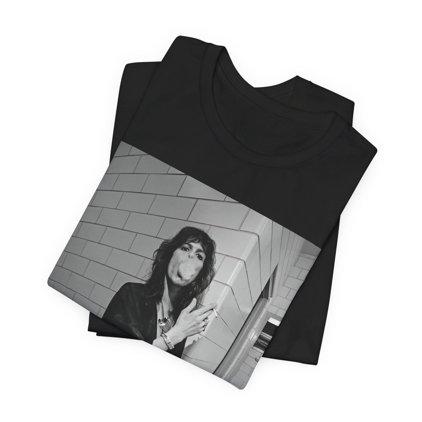 A black graphic t-shirt featuring a retro 70s photo of Aerosmith band members in a backstage setting, showing a candid moment.