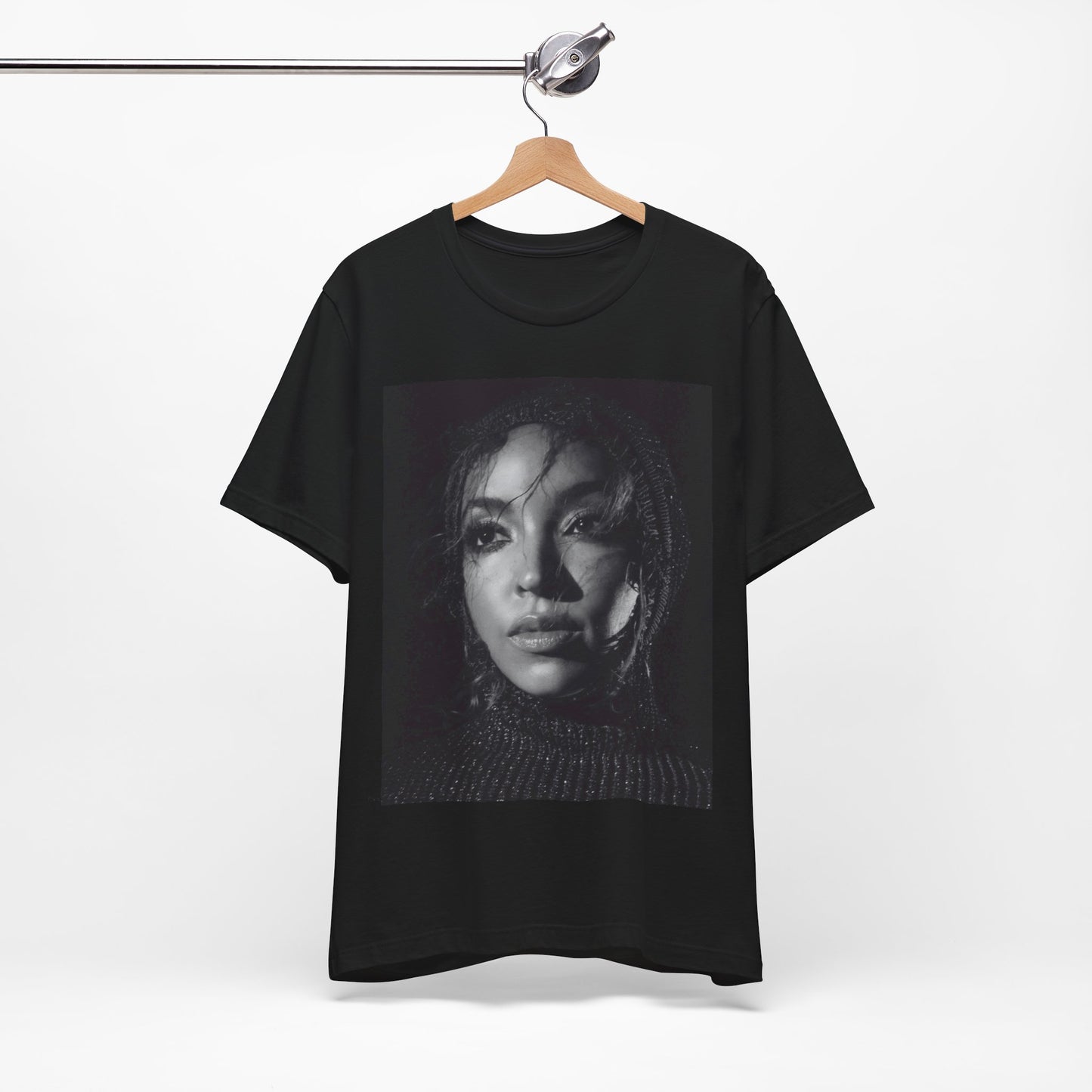 A black graphic t-shirt featuring a black and white portrait photo of Tinashe.