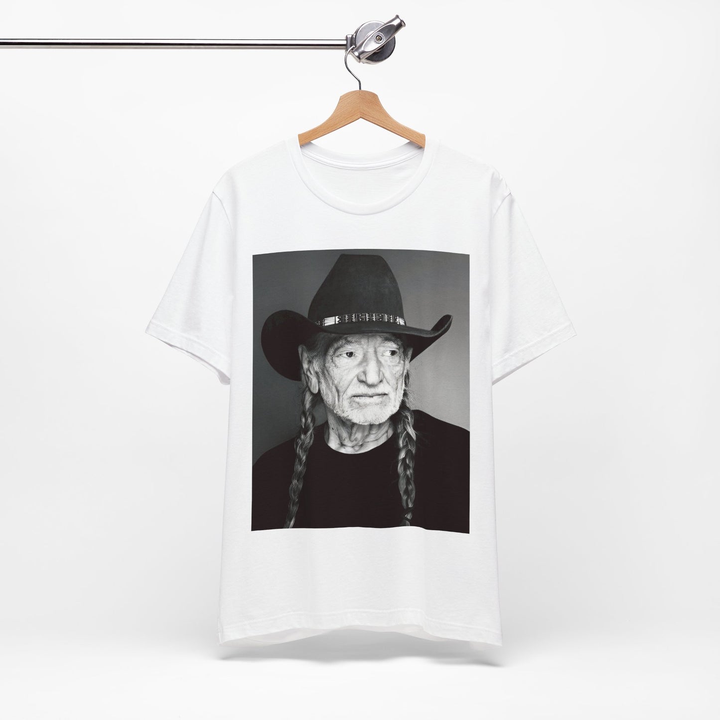 A black graphic t-shirt featuring a graphic of Willie Nelson with his iconic guitar 'Trigger'.
