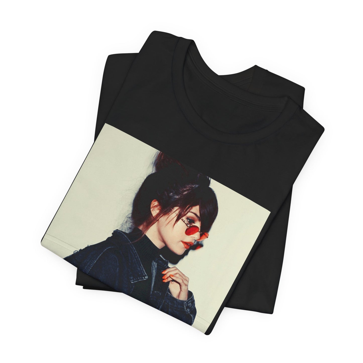 A black graphic t-shirt featuring a bold graphic of Selena Gomez as a pop superstar.