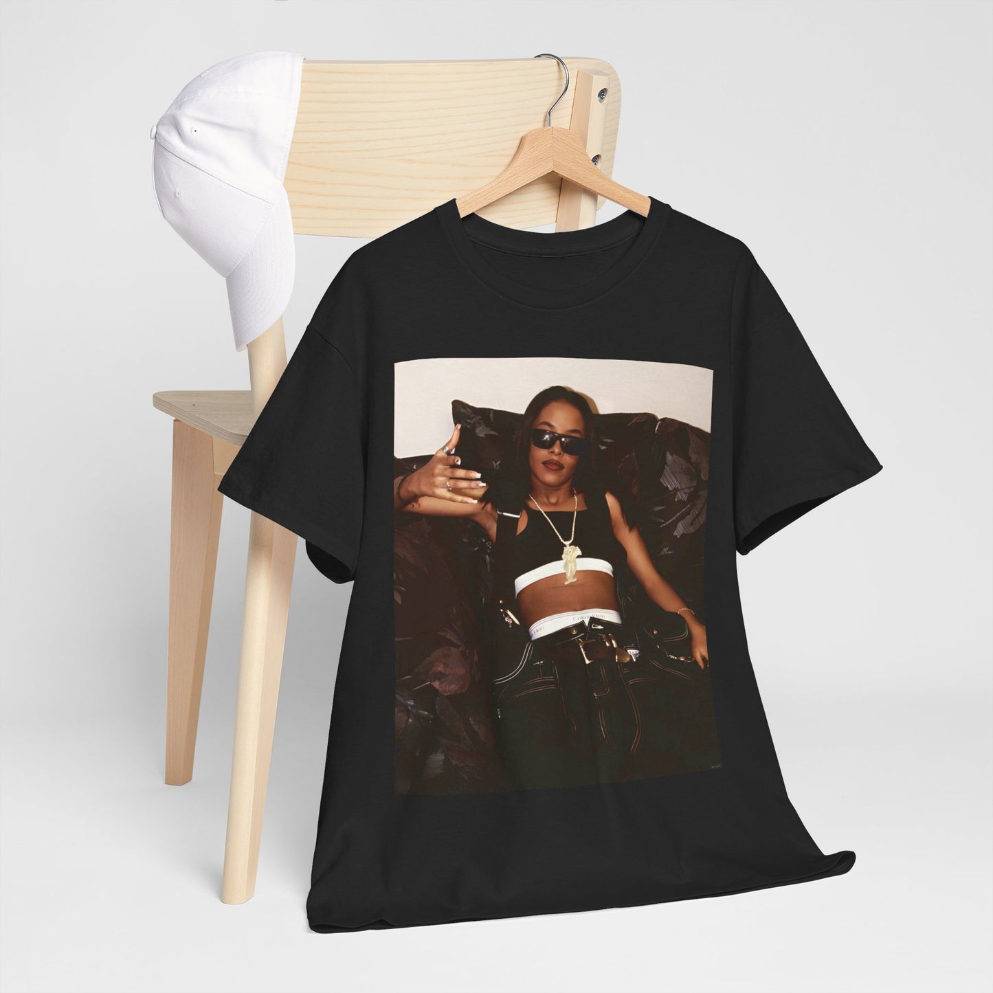 A black graphic t-shirt featuring a bold R&B superstar graphic of Aaliyah.