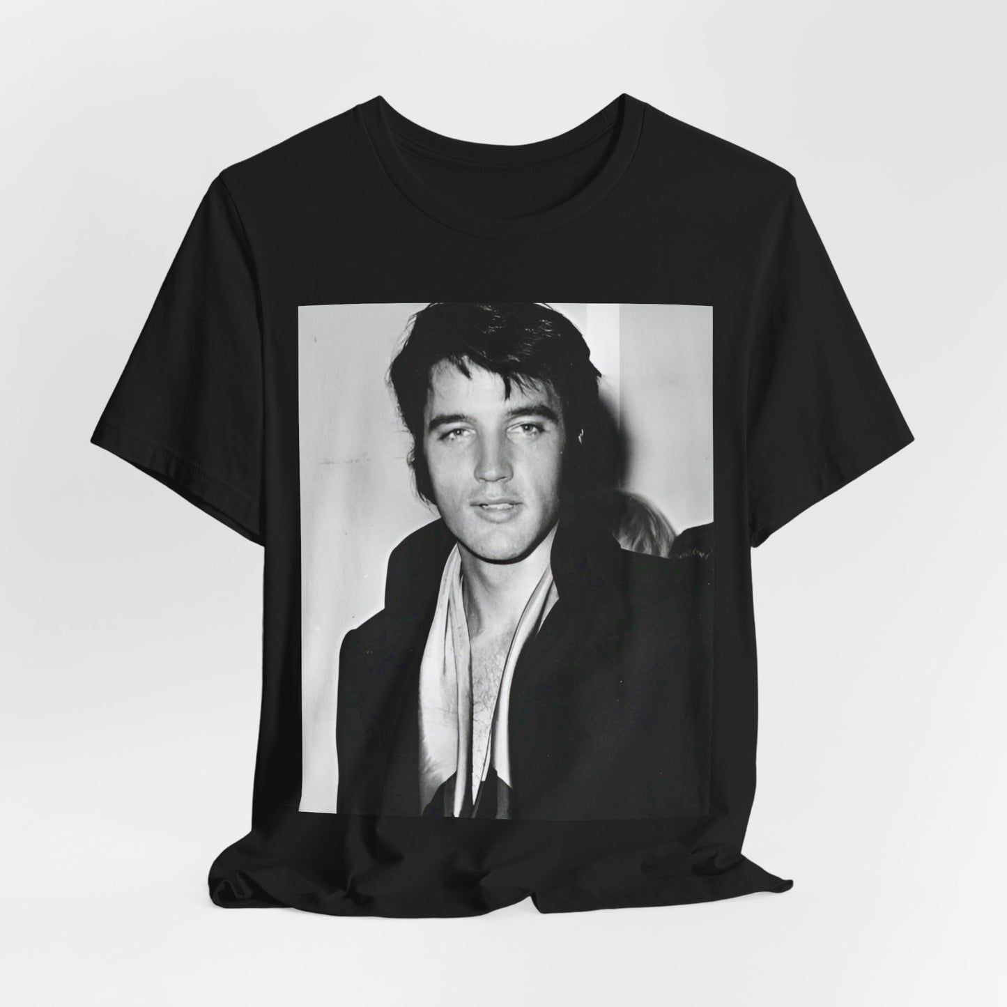 A black graphic t-shirt featuring a black and white rock and roll portrait photo of Elvis Presley.