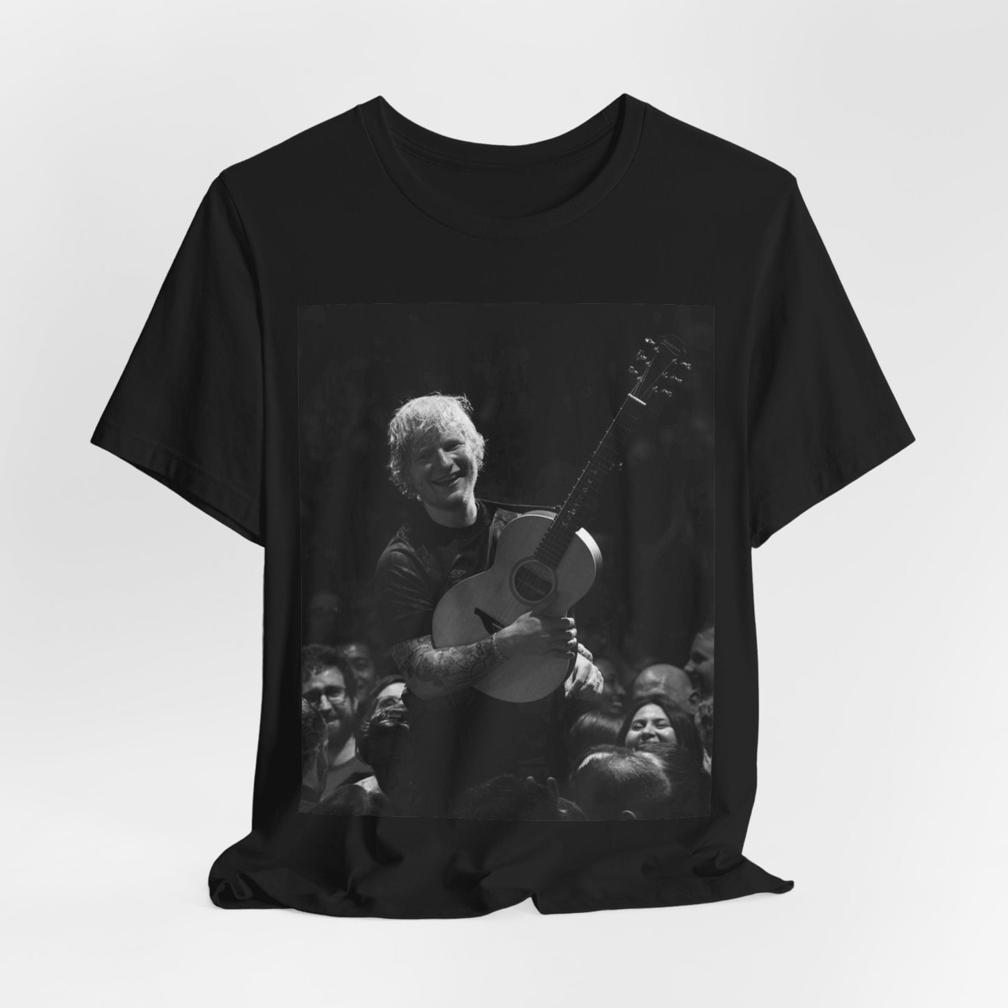 A black graphic t-shirt featuring a photo of Ed Sheeran performing live with his guitar.