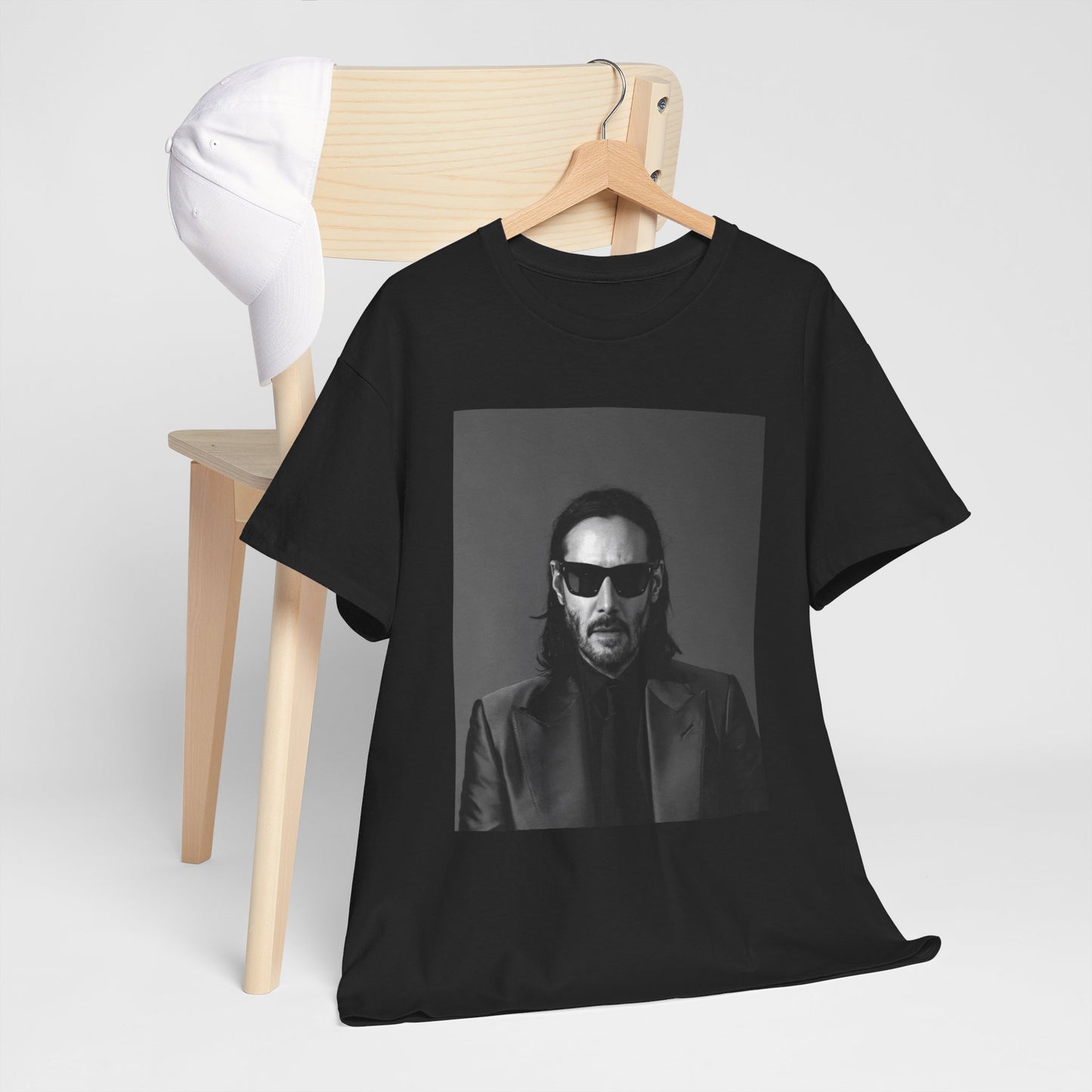 A black graphic t-shirt featuring an aesthetic graphic of Keanu Reeves as an action hero.