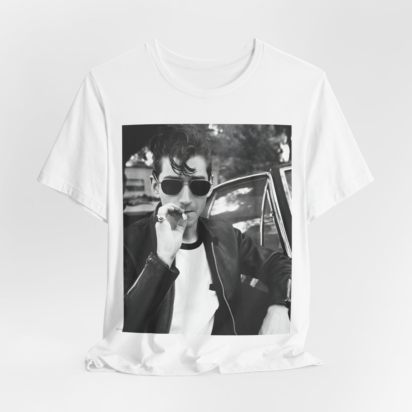 A black graphic t-shirt featuring a classic rock-style graphic of the Arctic Monkeys, possibly with band members in a stylized design.