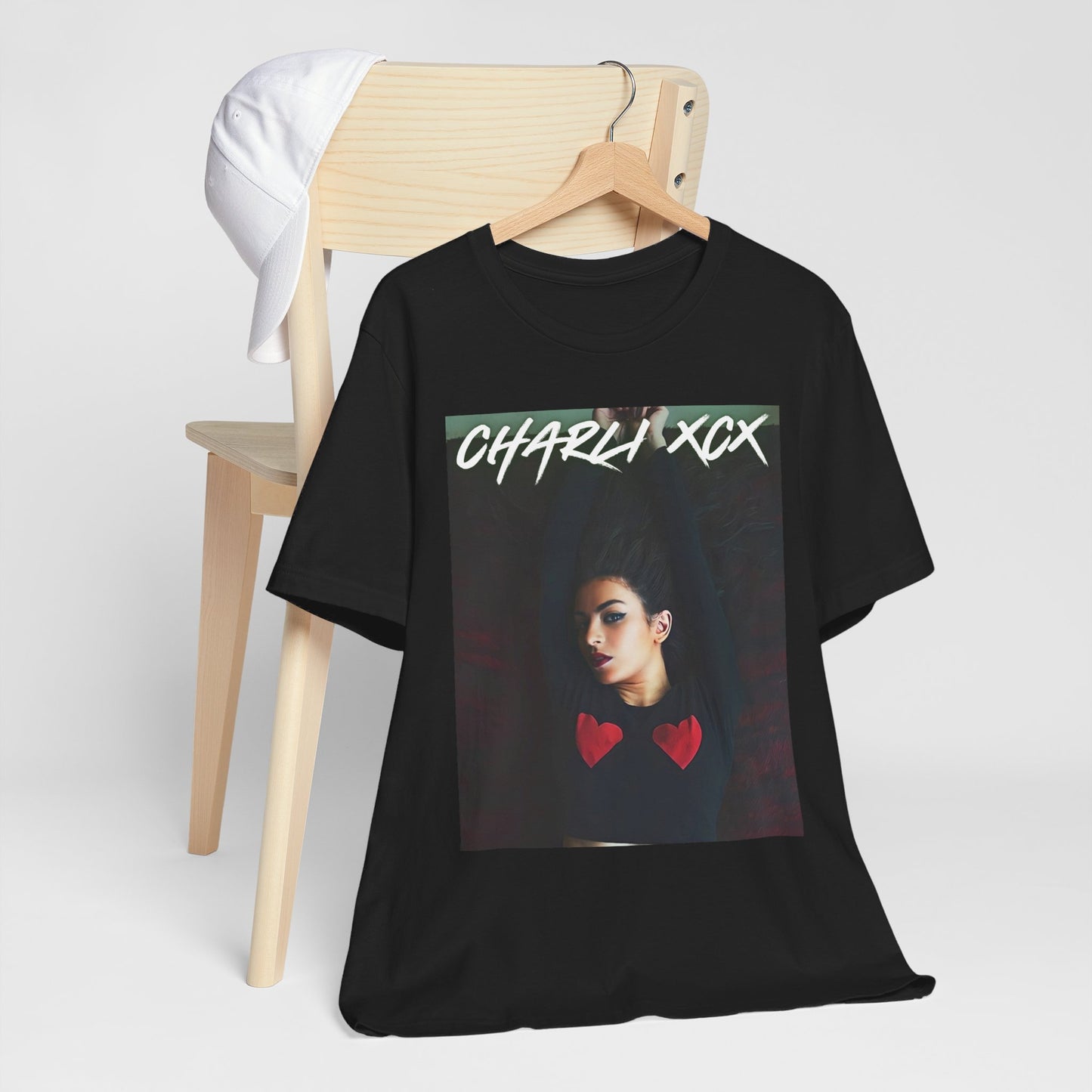 A black graphic t-shirt featuring a graphic of Charli XCX, designed with a future pop diva aesthetic.