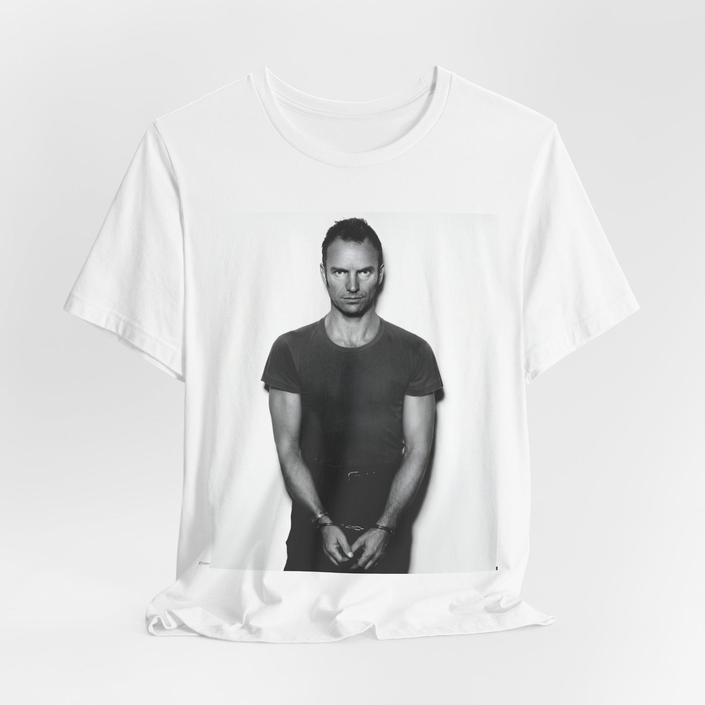 A black graphic t-shirt featuring a black and white portrait photo of Sting.
