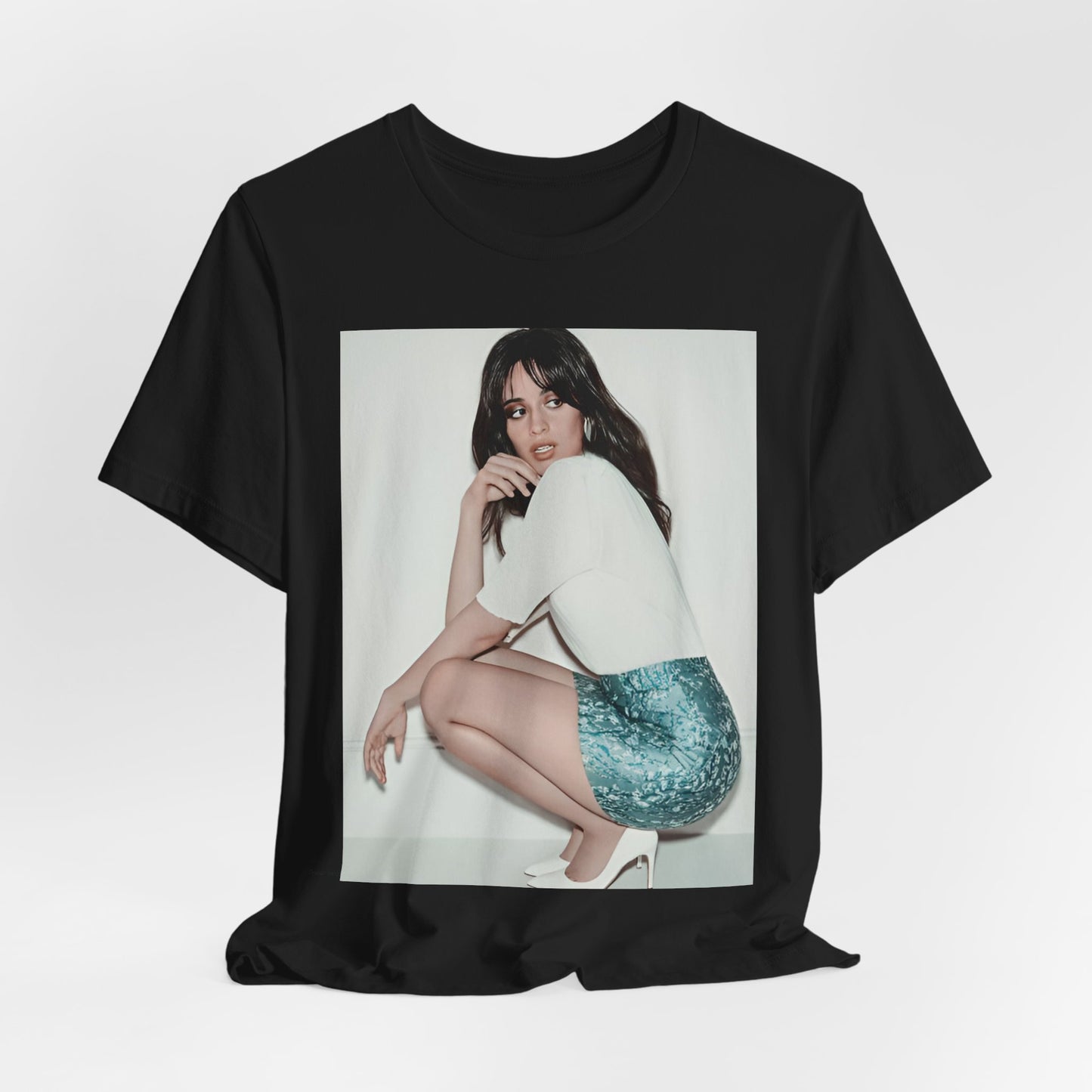 A black graphic t-shirt featuring a stylized graphic of Camila Cabello as a Latin pop princess.