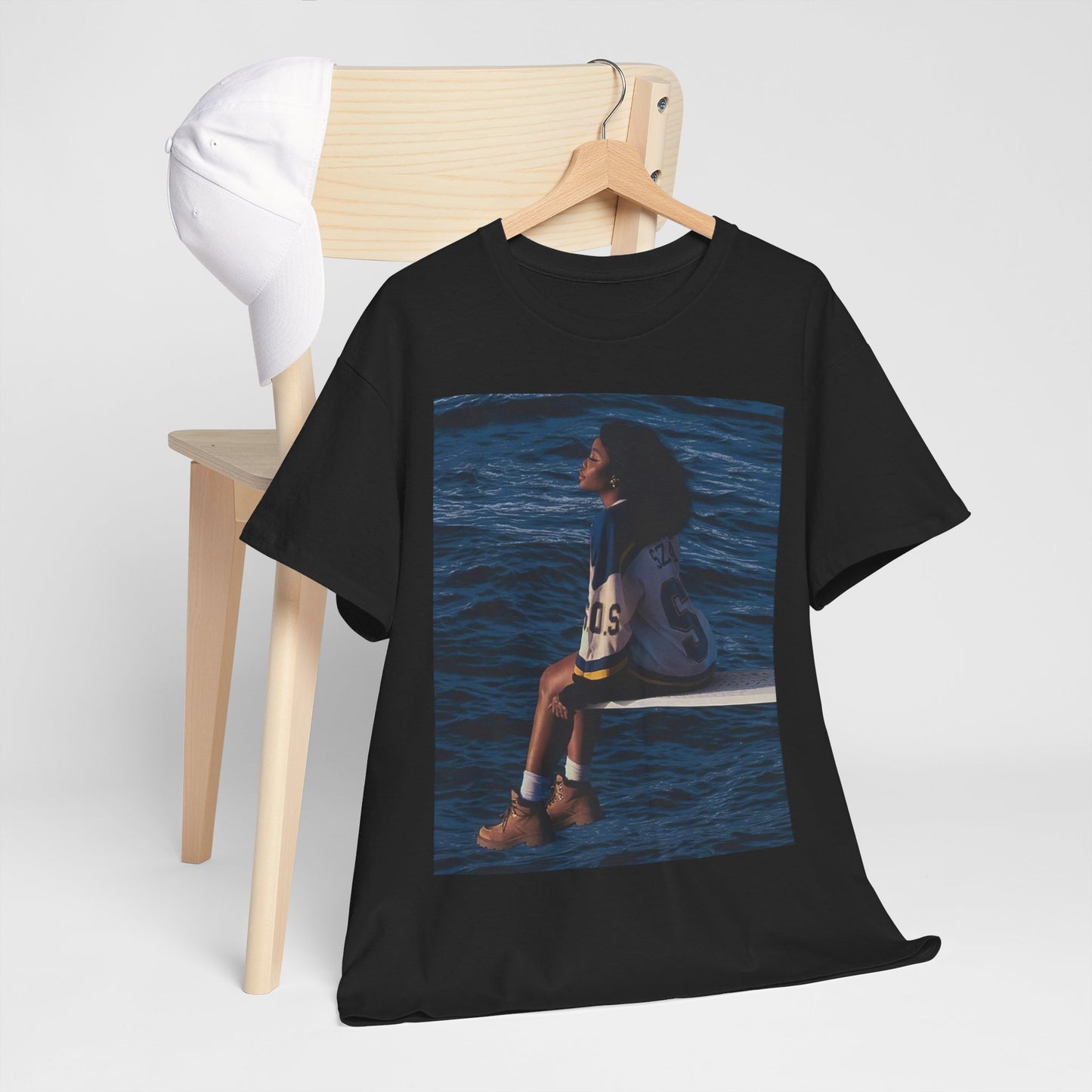 A black graphic t-shirt featuring a graphic related to SZA's 'SOS' album.