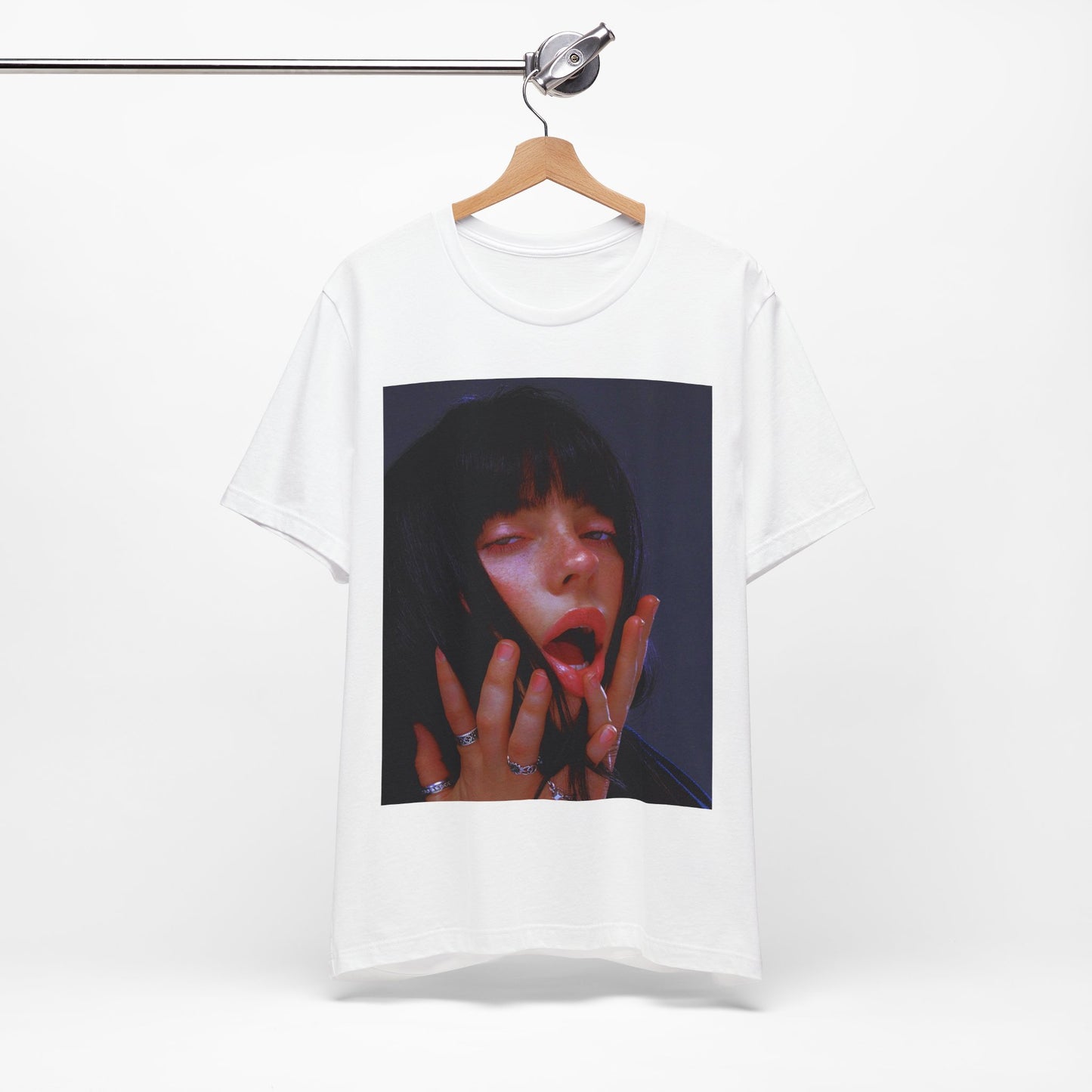 An intense, artistic photo of Billie Eilish with a bloody nose, conveying a sense of raw power, printed on a graphic t-shirt.