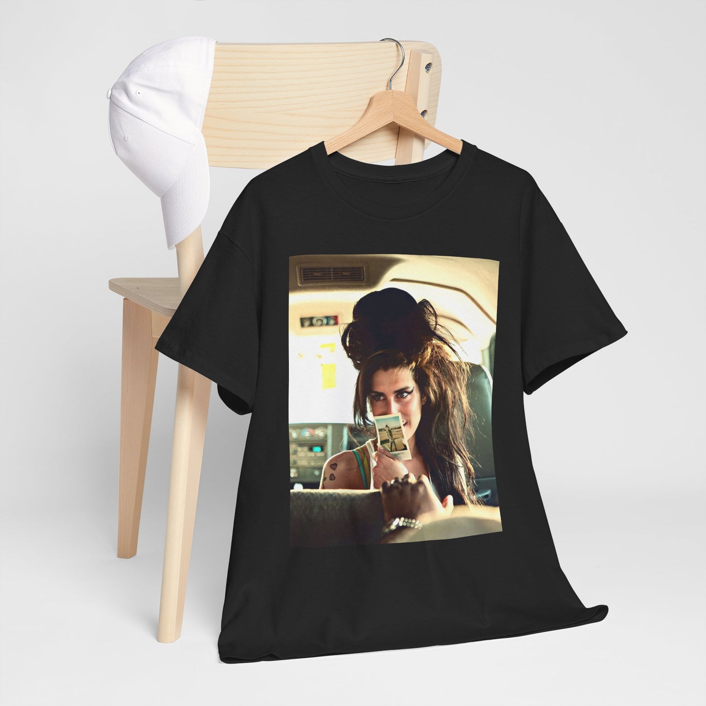 A black graphic t-shirt featuring a chaotic or candid graphic of Amy Winehouse offstage, capturing her intense or expressive moments.