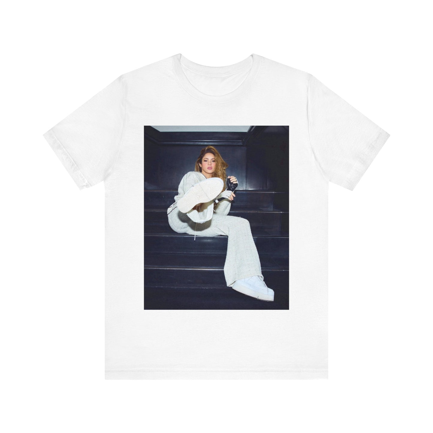 A black graphic t-shirt featuring a vintage Latin pop icon graphic of Shakira.