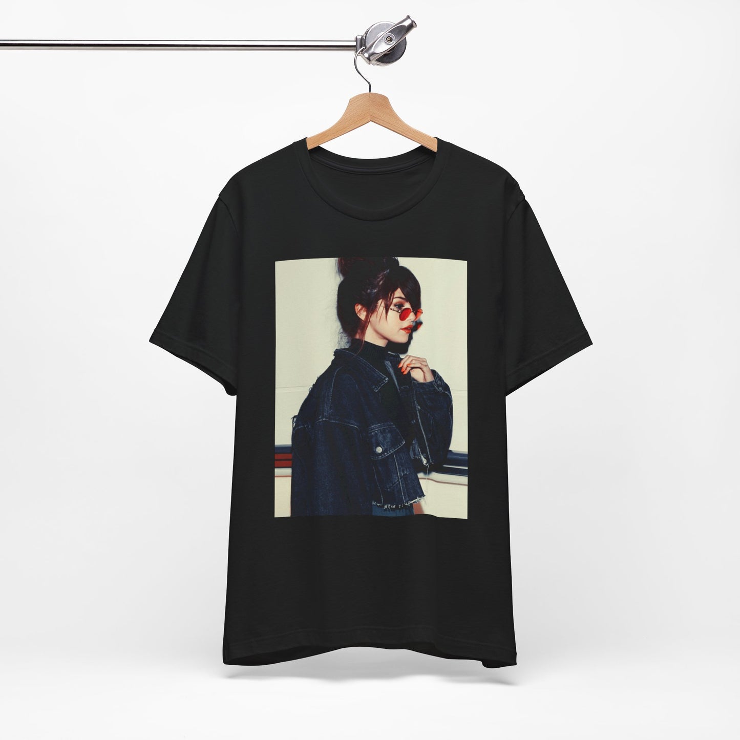 A black graphic t-shirt featuring a bold graphic of Selena Gomez as a pop superstar.