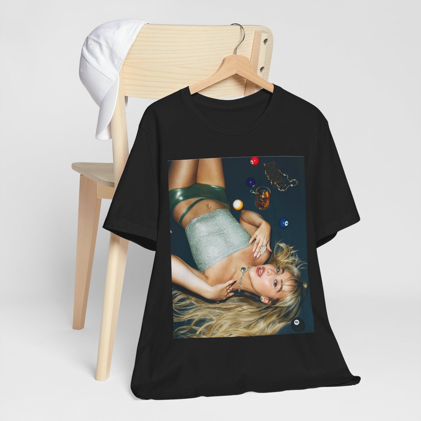 A black graphic t-shirt featuring a vintage pop icon graphic of Sabrina Carpenter.