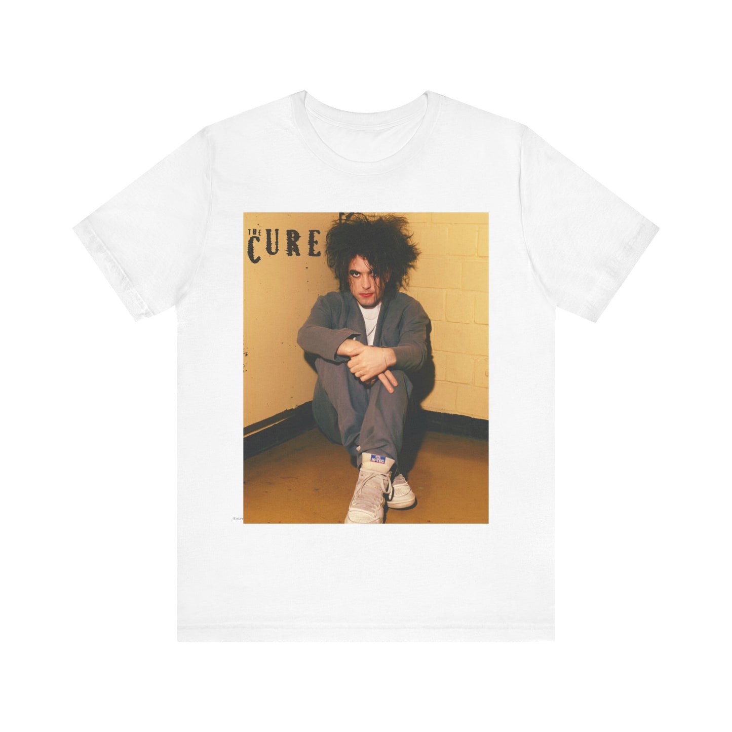 A black graphic t-shirt featuring a bold goth rock superstar graphic of The Cure.