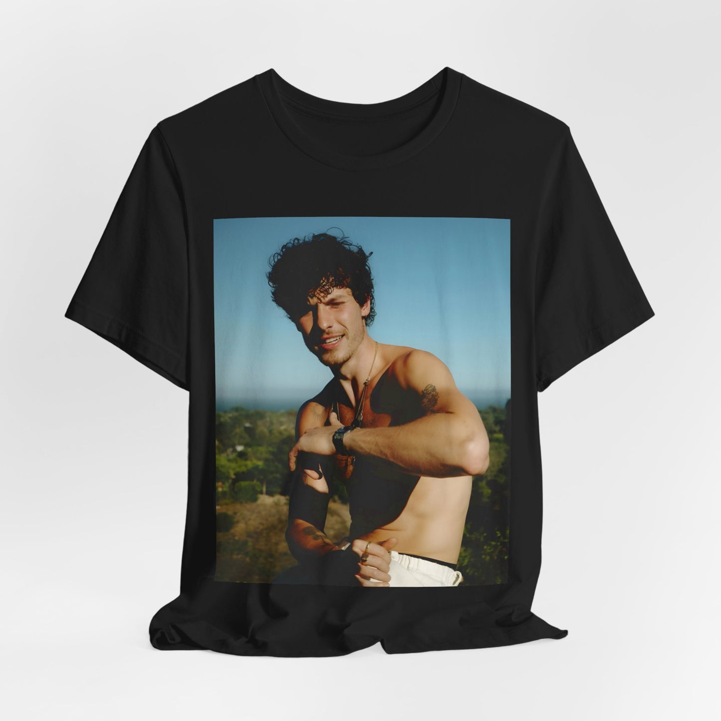 A black graphic t-shirt featuring a graphic of Shawn Mendes with a chill pop star look.