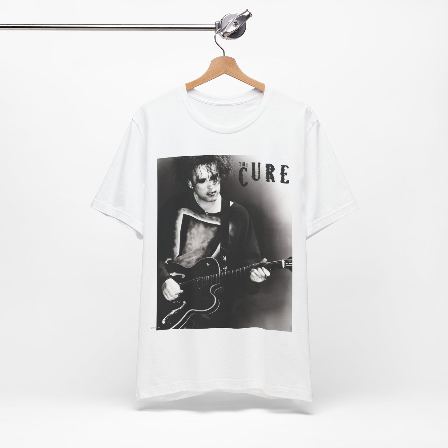 A black graphic t-shirt featuring a vintage goth rock graphic of The Cure.