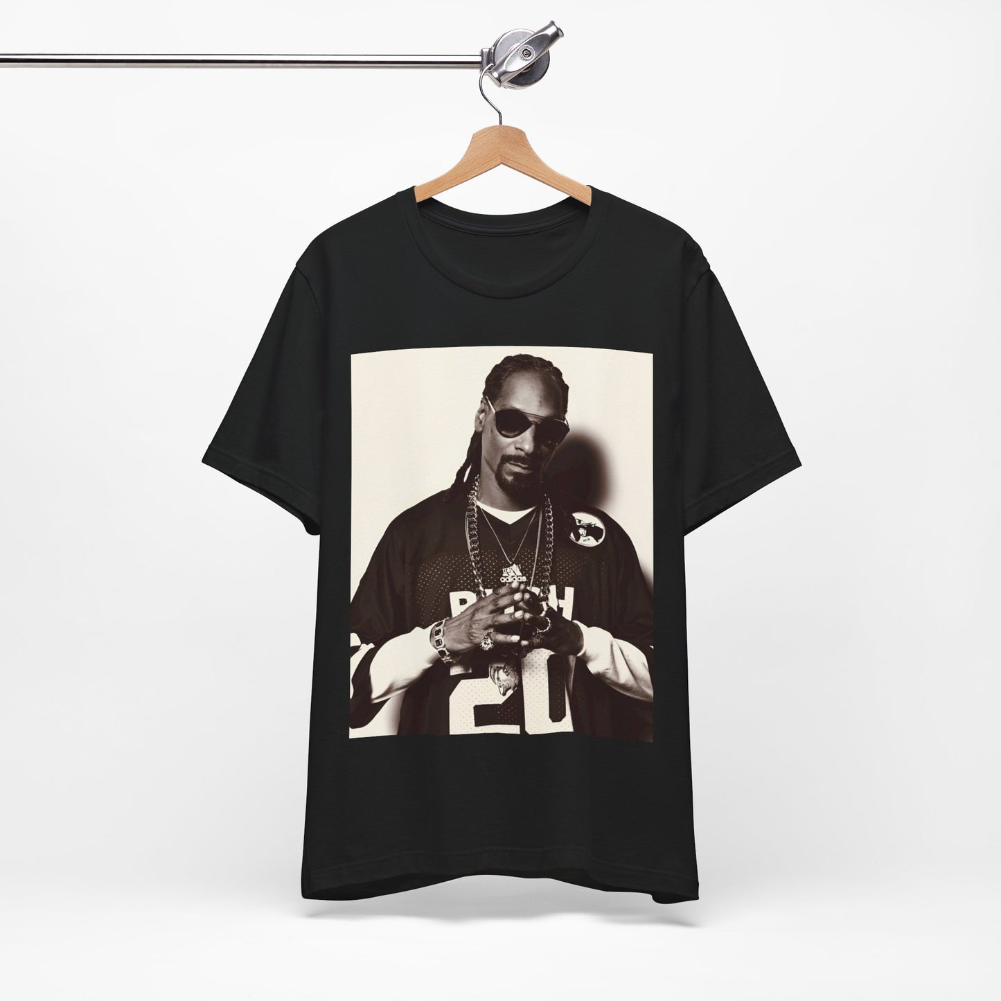 A black graphic t-shirt featuring a black and white, monochrome graphic or photo of Snoop Dogg in an OG style.