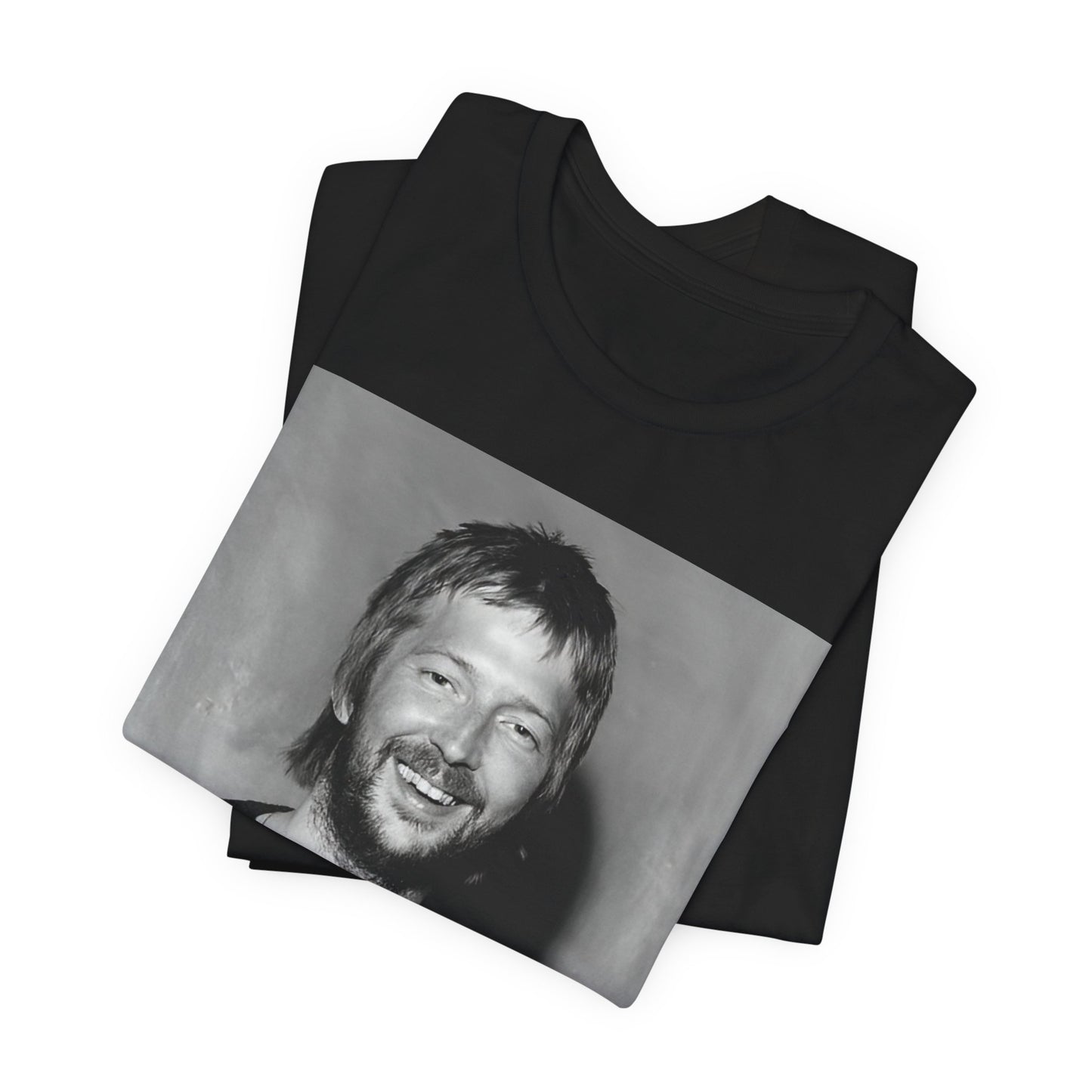 A black graphic t-shirt featuring a 70s photo portrait of Eric Clapton.