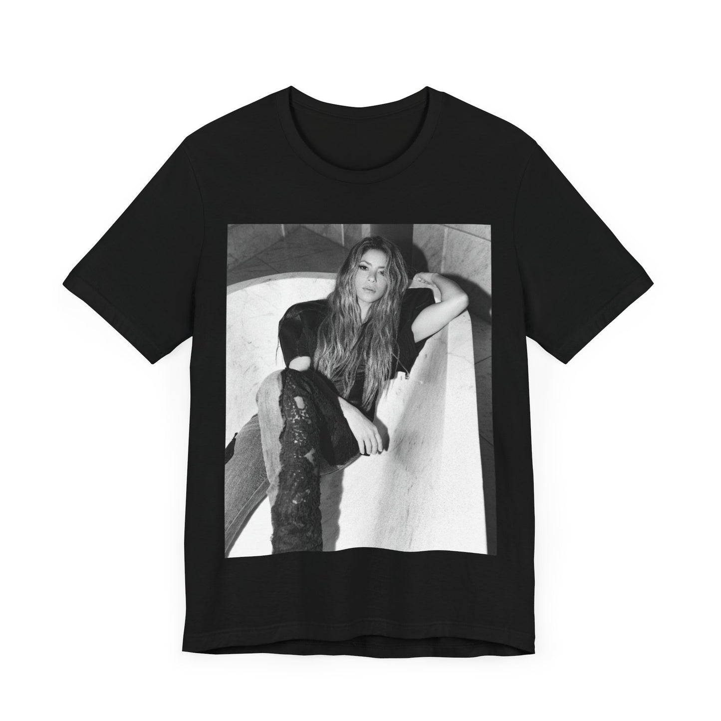 A black graphic t-shirt featuring a retro graphic related to Shakira's 'Hips Don't Lie' song or era.