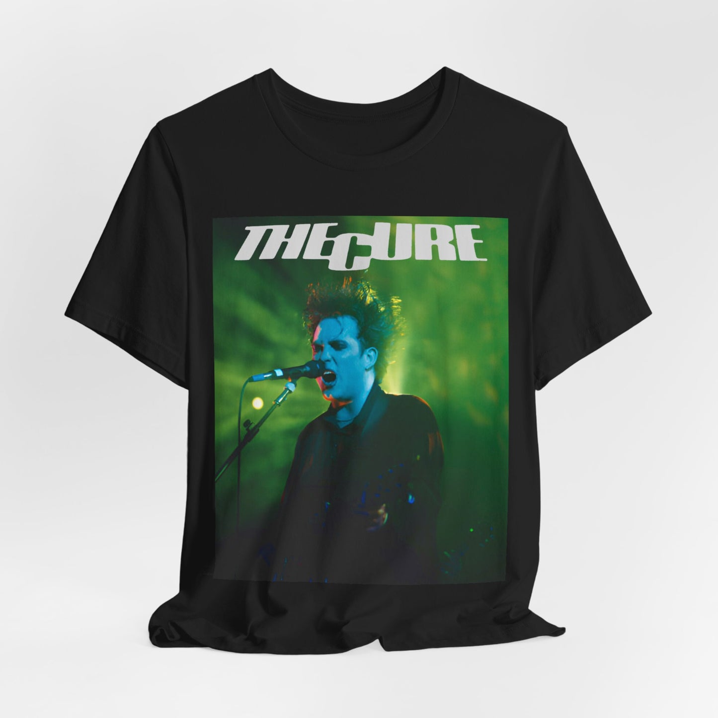A black graphic t-shirt featuring a graphic or photo of The Cure performing live on stage.