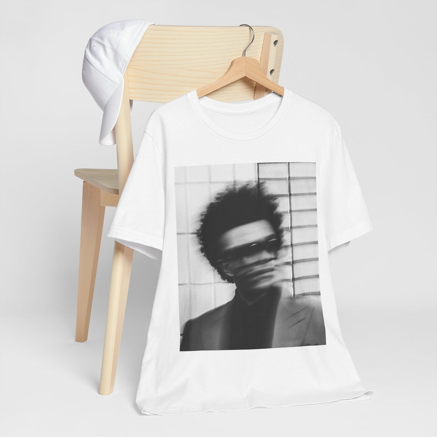 A black graphic t-shirt featuring a blurred graphic of The Weeknd from his 'After Hours' era.