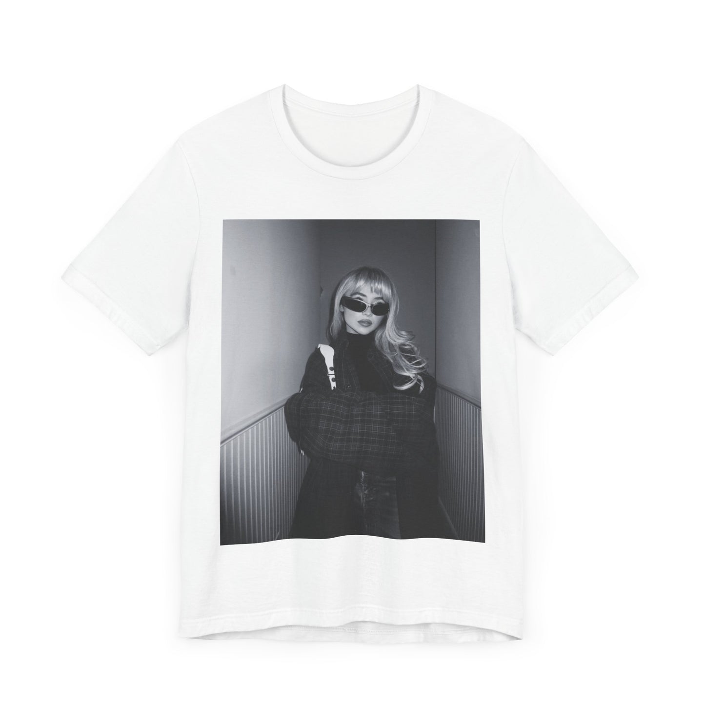 A black graphic t-shirt featuring a black and white glam pop diva graphic of Sabrina Carpenter.