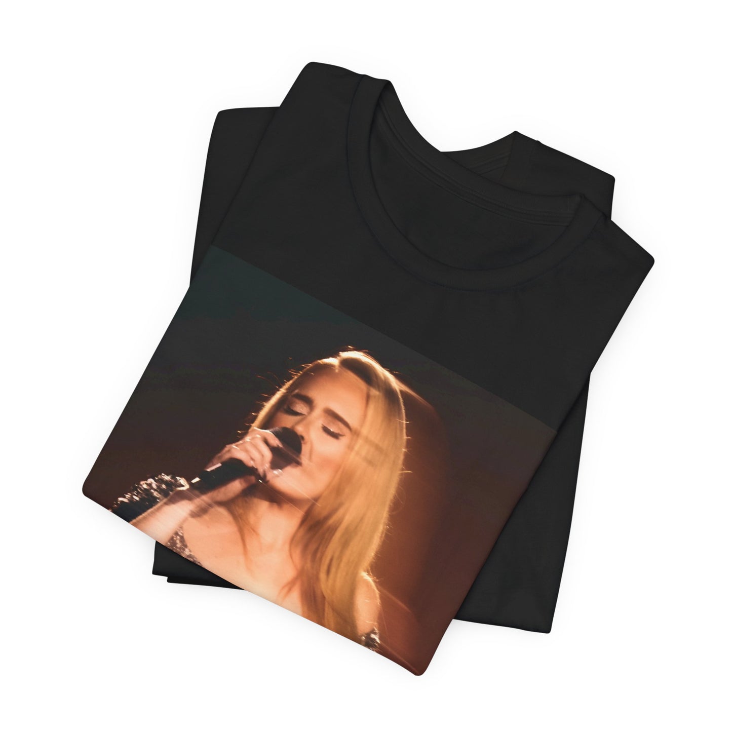 A black graphic t-shirt featuring a stylized image or photo of Adele related to her Las Vegas residency, possibly with elements of stage lighting or show branding.