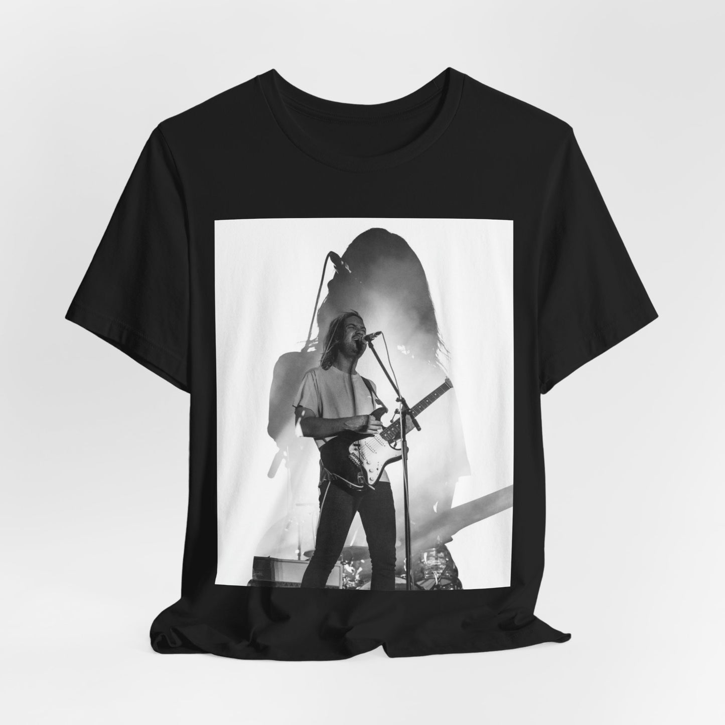 A black graphic t-shirt featuring a black and white, monochrome graphic or photo of Tame Impala.