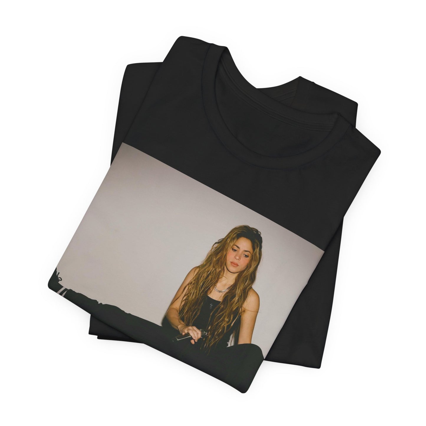 A black graphic t-shirt featuring a modern pop essential graphic of Shakira.