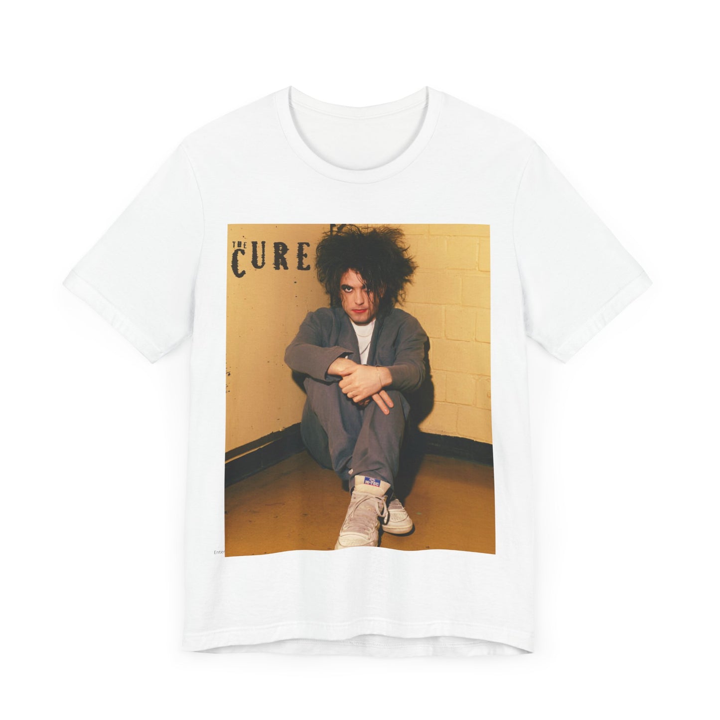 A black graphic t-shirt featuring a bold goth rock superstar graphic of The Cure.