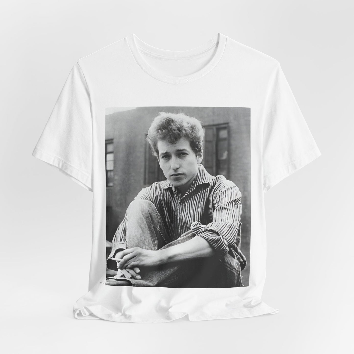 A black graphic t-shirt featuring a graphic of Bob Dylan from his 60s origins in folk music.