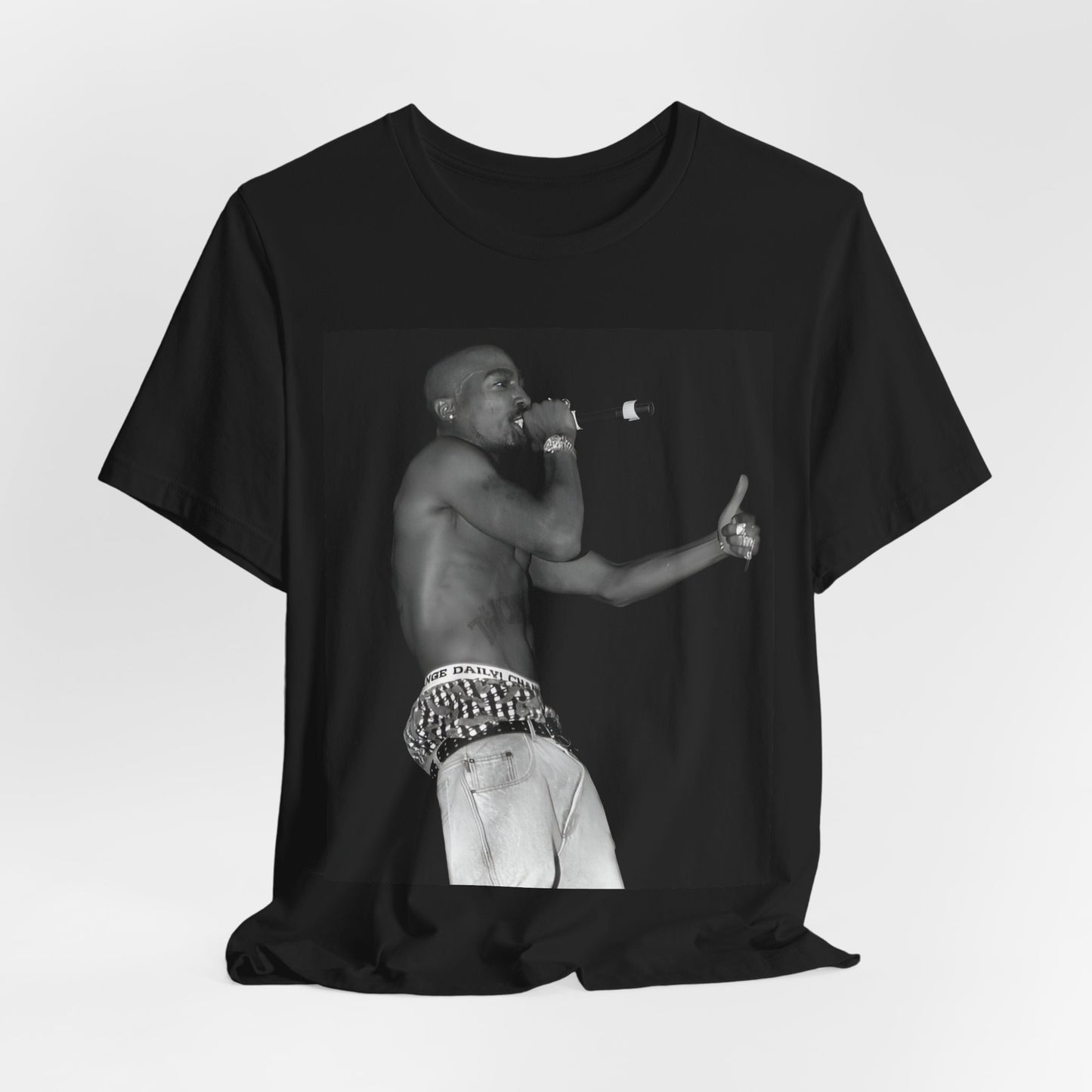 A black graphic t-shirt featuring a graphic of Tupac as a justice fighter.