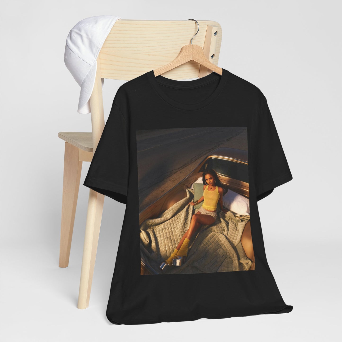 A black graphic t-shirt featuring a graphic of Tyla as an African fashion icon.