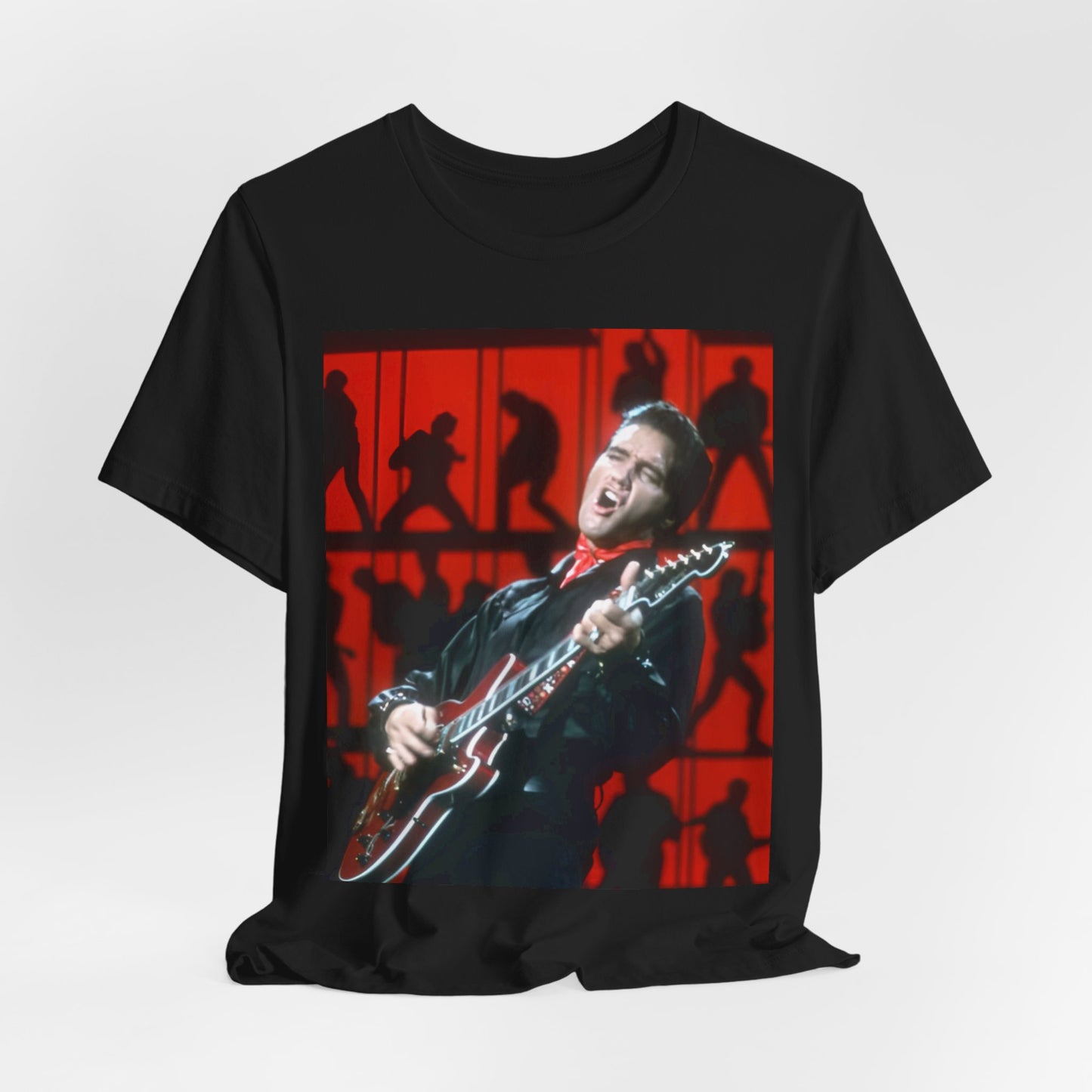 A black graphic t-shirt featuring a vintage photo of Elvis Presley from his Las Vegas residency.