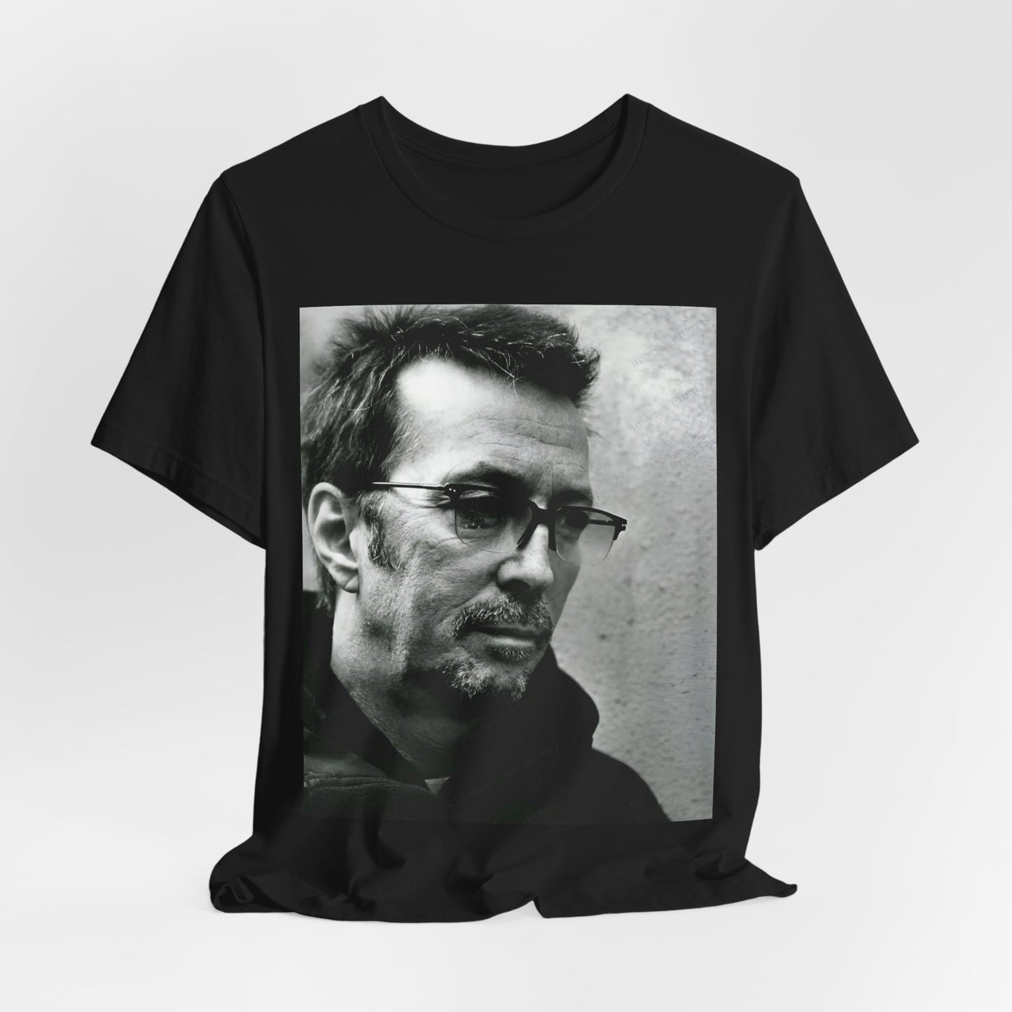 A black graphic t-shirt featuring a black and white, monochrome graphic or photo of Eric Clapton.