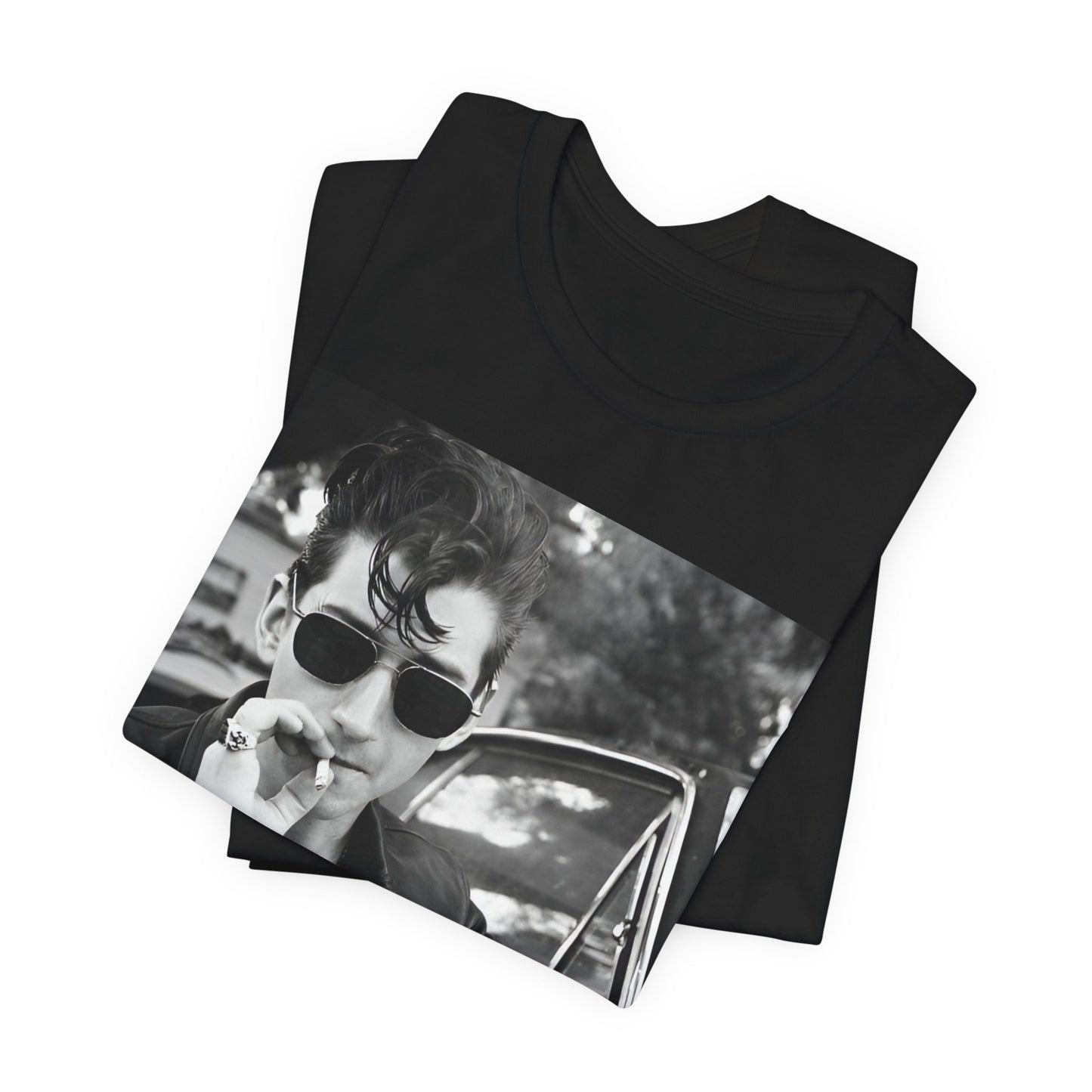 A black graphic t-shirt featuring a classic rock-style graphic of the Arctic Monkeys, possibly with band members in a stylized design.