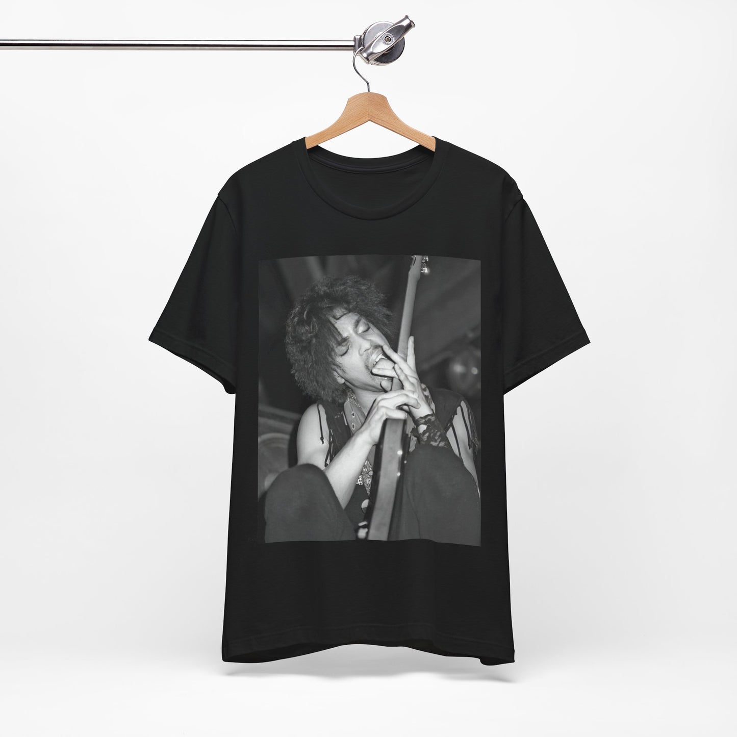 A black graphic t-shirt featuring a graphic or photo of Prince performing wildly on stage.