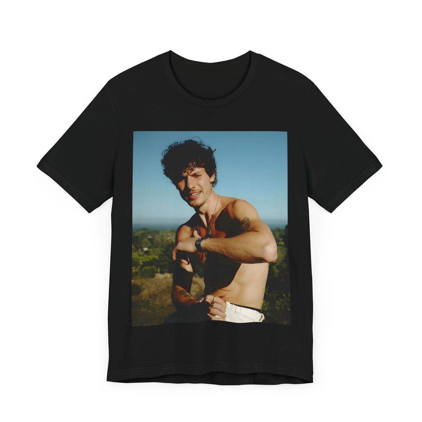 A black graphic t-shirt featuring a graphic of Shawn Mendes with a chill pop star look.