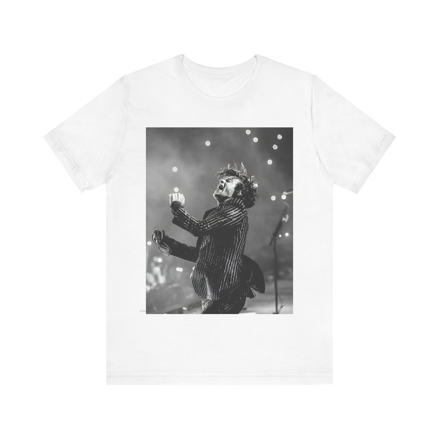 A black graphic t-shirt featuring a glamorous graphic or photo of Harry Styles performing on stage.