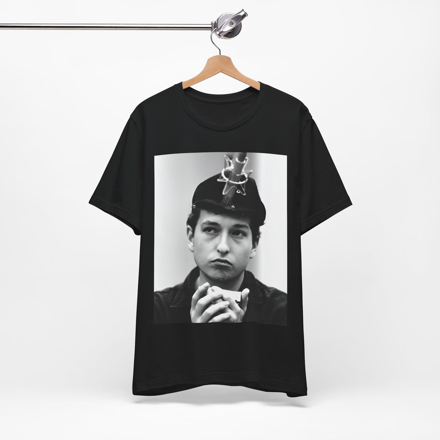 A black graphic t-shirt featuring a graphic of Bob Dylan in an acoustic session setting, possibly with his guitar.