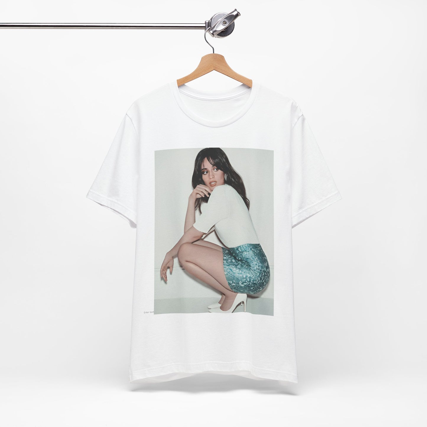A black graphic t-shirt featuring a stylized graphic of Camila Cabello as a Latin pop princess.