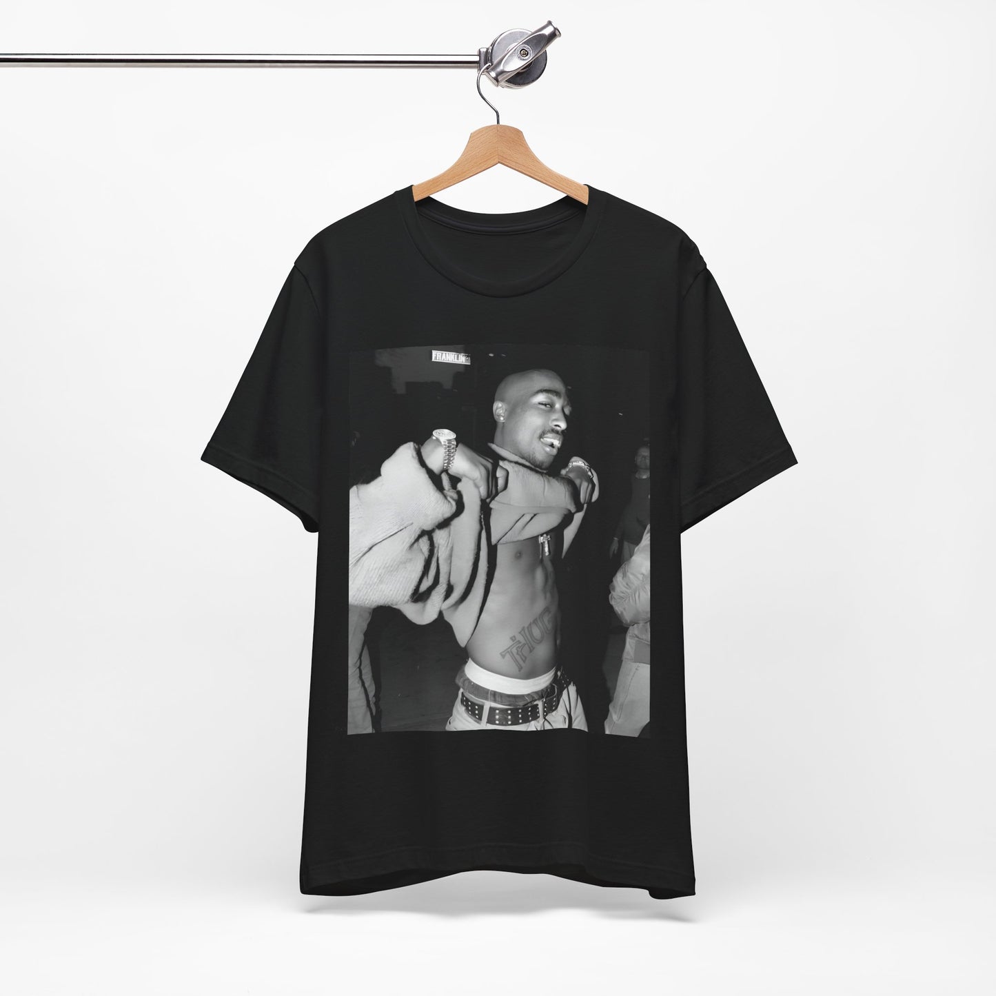 A black graphic t-shirt featuring a vintage hip hop icon graphic of Tupac.