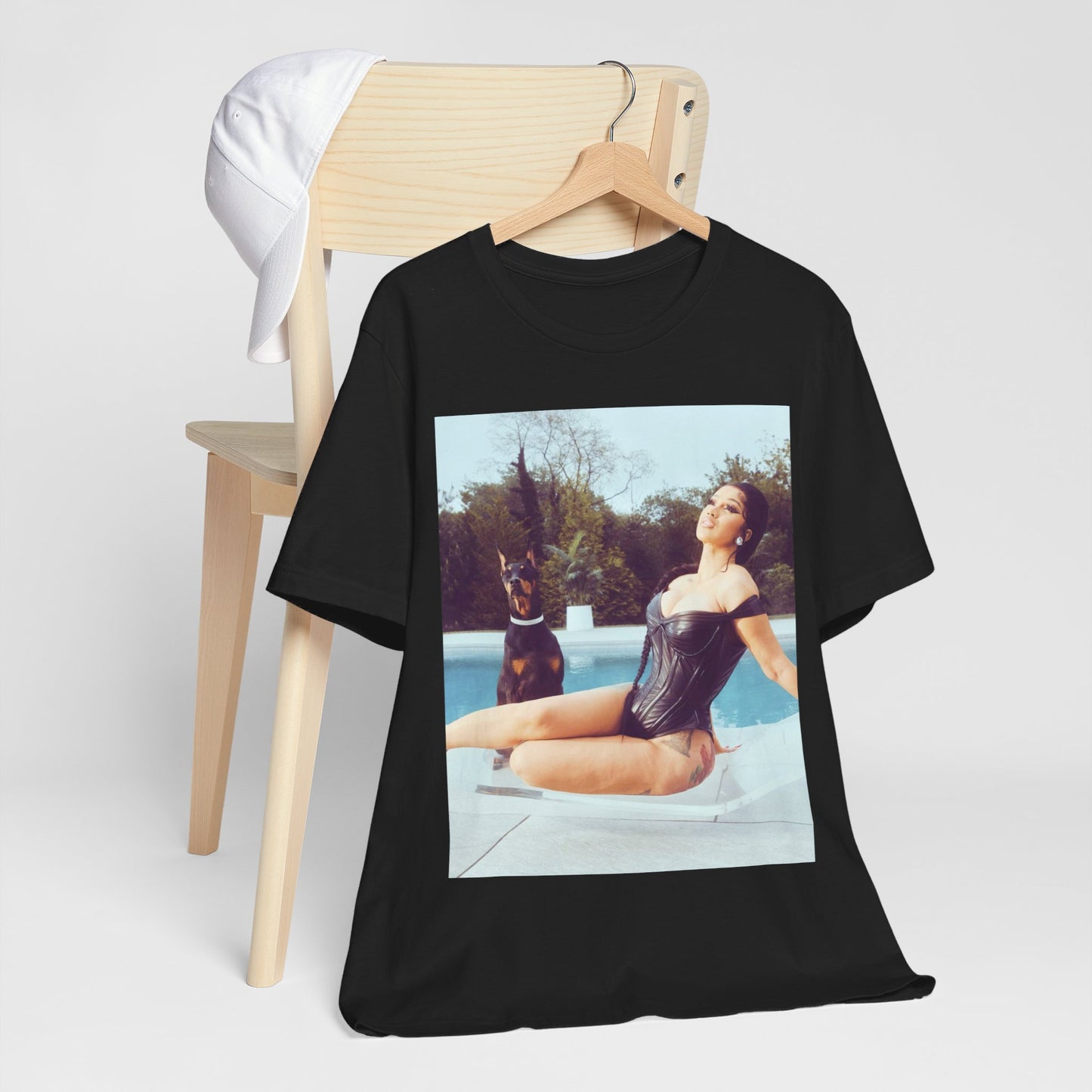 A black graphic t-shirt featuring a graphic related to Cardi B's 'I Like It' song, with bold pop culture elements.