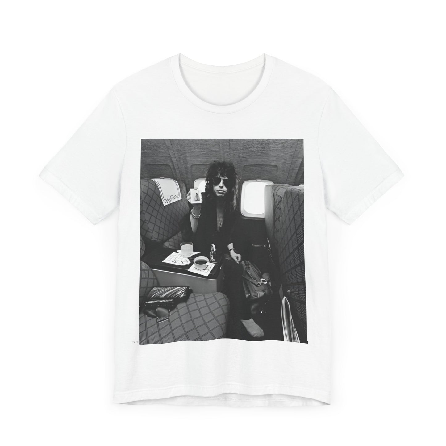 A black graphic t-shirt featuring a vintage 70s-style illustration of an airplane with Aerosmith branding, representing their tour plane from that era.